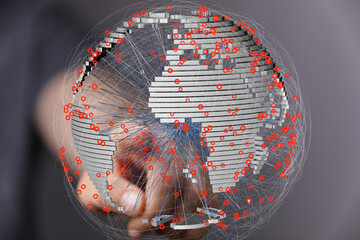 Stock photo of a hand interacting with a 3D model of the Earth, showing interconnectedness and data...