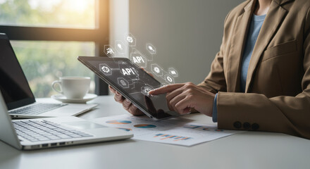 API Integration: Professional Woman Navigating Applications on Tablet for Business Growth in Bright Office