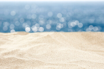 Beach Sand with Copy Space – Summer Seaside Background with Bokeh Sea and Blue Sky. Sunny vacation mockup.