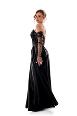 Fototapeta premium Elegant woman in a sequined black gown poses gracefully against a white background