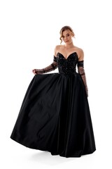 Elegant evening gown on display by a model in a studio setting showcasing fashion design and style