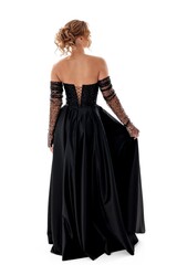 Fototapeta premium Elegant black evening gown showcases intricate beadwork and flowing fabric in a studio setting