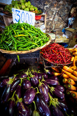 Beautiful view of fresh, delicious-looking chili peppers, eggplants, and other vegetables at a farmers' market in Port Louis, Mauritius, Africa