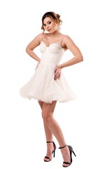 Model poses gracefully in a white dress, showcasing elegance and style in a studio setting