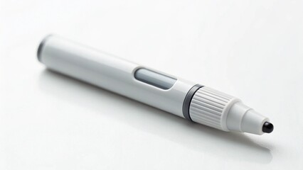 Close-up of a Lamy Pico white ballpoint pen with its distinctive grey push-button mechanism, lying on a pristine white background, emphasizing its sophisticated simplicity