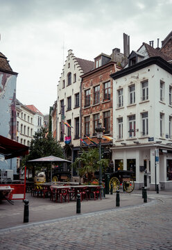 Rue du March&eacute; au Charbon street in central Brussels. Popular pedestrian street in old town with many cafes and stores. Narrow cobbled street on a cloudy day. Brussels, Belgium - October 09 2014