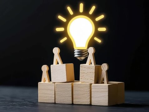 A creative concept illustrating teamwork, with wooden blocks and a glowing light bulb symbolizing ideas and innovation.