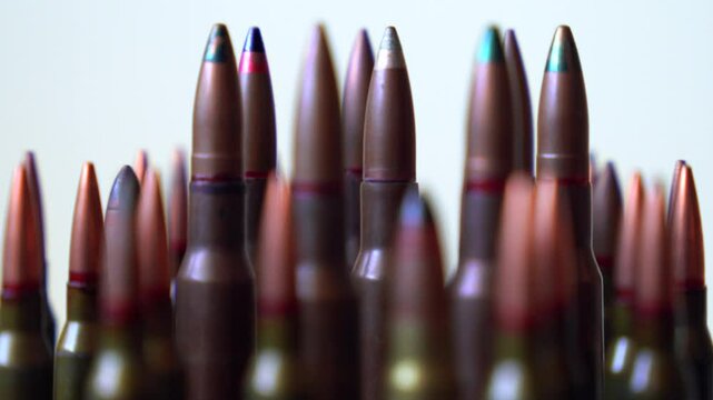 Different types of different types of bullets close-up rotating on white background, shallow depth of field