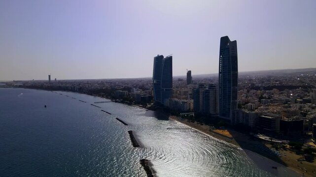 Evening sunset over Limassol, Cyprus. Aerial view of modern urban architecture and glass skyscrapers of Cyprus. Mediterranean Sea near Limassol, Cyprus. High quality footage 4k