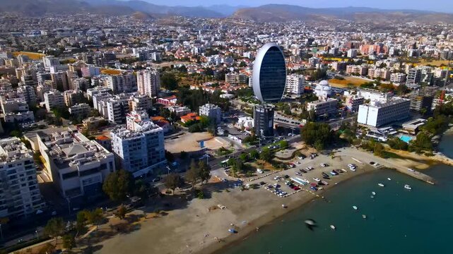 Evening sunset over Limassol, Cyprus. Aerial view of modern urban architecture and glass skyscrapers of Cyprus. Mediterranean Sea near Limassol, Cyprus. High quality footage 4k