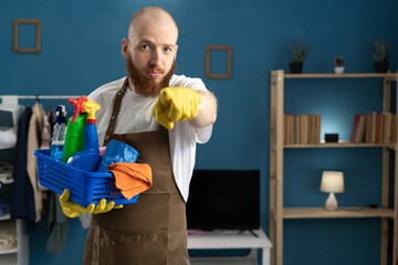 Janitor with cleaning basket angry pointing and accountability for you standing in the living room at home