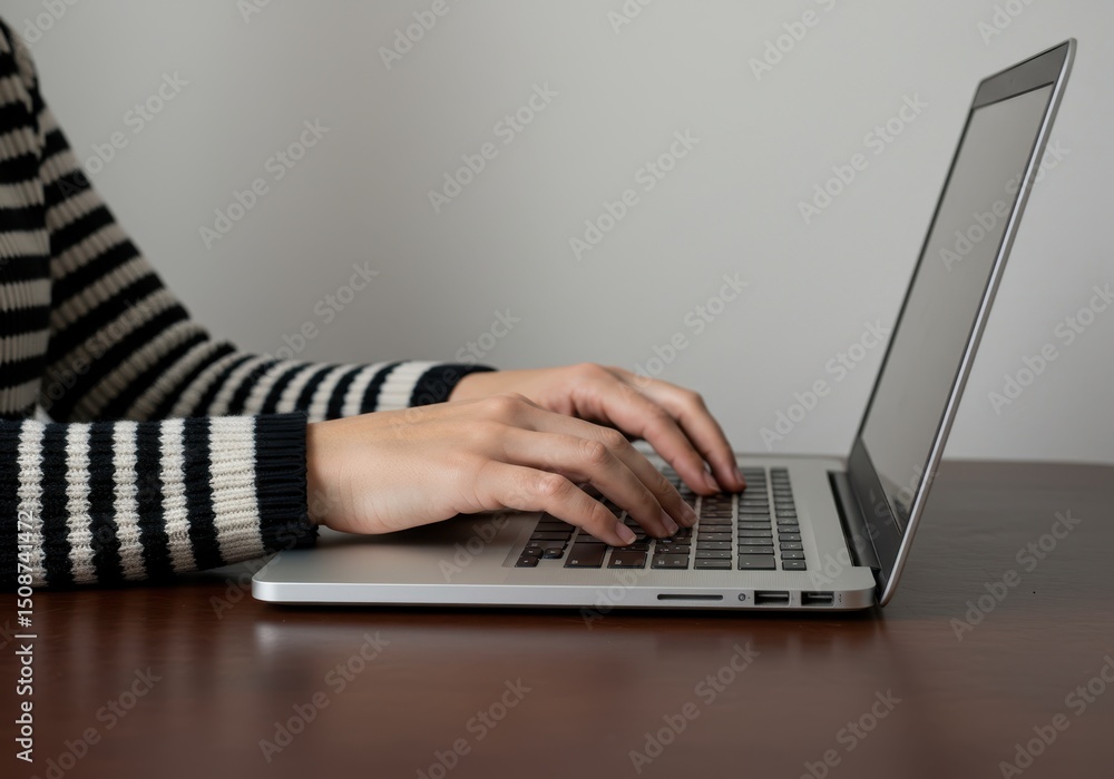Poster hands typing on a laptop computer at a desk, working or studying