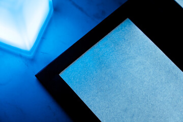 Top view of Modern Restaurant Menu Under Blue Ambient Light