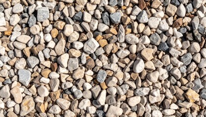 Close-up of irregular mixed gravel stones in warm daylight

