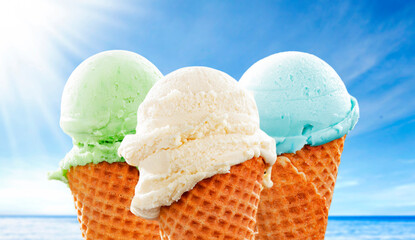 Colorful Fruit Scoop Ice Cream Cone Against Blue Sky on Hot Summer Day - hot summer and beach vibes. Refreshing scene perfect for summer treats, vacation, seaside fun and vacation lifestyle concepts.