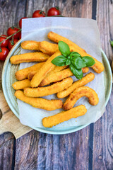 Crispy  deep fried home made    chicken strips Breaded  with  almond flour chicken  breast fillets  with chilly peppers and fresh   basil on wooden rustic background. Ketogenic diet food