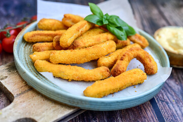 Crispy  deep fried home made    chicken strips Breaded  with  almond flour chicken  breast fillets  with chilly peppers and fresh   basil on wooden rustic background. Ketogenic diet food
