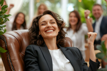 Caucasian adult woman celebrating success with colleagues in bright office setting