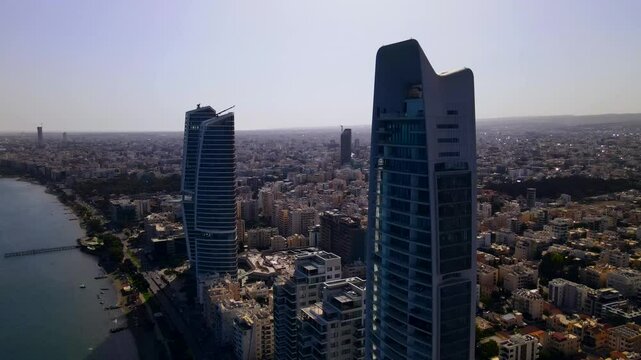 Evening sunset over Limassol, Cyprus. Aerial view of modern urban architecture and glass skyscrapers of Cyprus. Mediterranean Sea near Limassol, Cyprus. High quality footage 4k