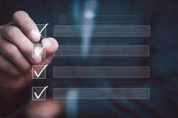 Businessman checklist concept as clipboard document checklist form on the virtual screen Use your hands or a pen to check the correct control gaps and check the quality standards of the work.