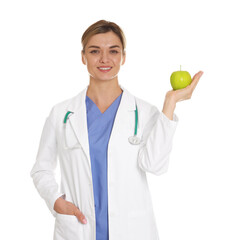 Nutritionist with green apple and stethoscope on white background