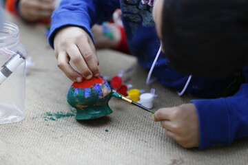 A little boy is painting