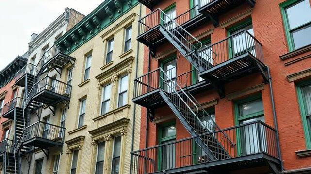 A multi-story building with a communal fire escape and a sense of community among residents,.