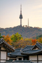 sunset scenery Autumn period Traditional Korean wooden house across from N Seoul Tower at Namsangol Hanok Village. Seoul, South Korea
