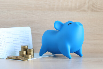 Piggy bank and stack of coins money on wooden background, Save money for prepare in future and pension retirement concept