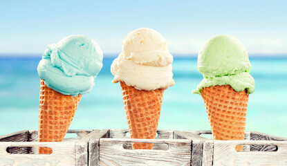 Colorful Fruit Scoop Ice Cream Cone Against Blue Sky on Hot Summer Day - hot summer and beach vibes. Refreshing scene perfect for summer treats, vacation, seaside fun and vacation lifestyle concepts.