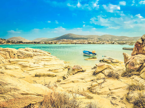 Romantic beach with rocks at greek island, Paros Greece with sunshine, panorama web format