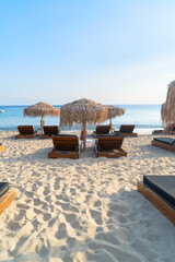 summer beach with sunbeds, Mykonos island, Greece