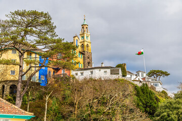 A view along the cliffs to the upper level of the colourful village of Portmeirion, Wales in springtime