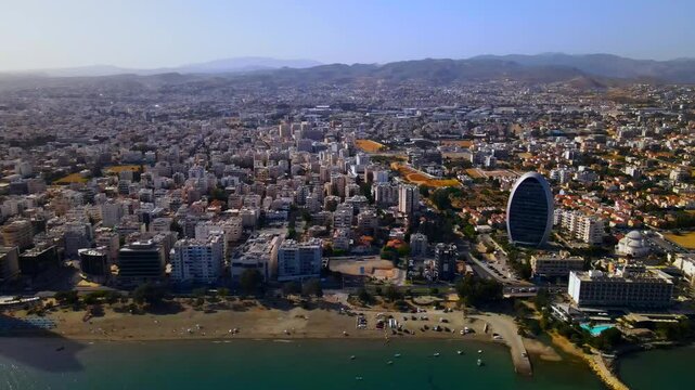 Evening sunset over Limassol, Cyprus. Aerial view of modern urban architecture and glass skyscrapers of Cyprus. Mediterranean Sea near Limassol, Cyprus. High quality footage 4k