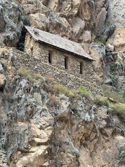 Ancient Inca ruins and stone fortifications at Ollantaytambo, Peru, showcasing impressive pre-Columbian architecture set against the dramatic Andes Mountains. A historic archaeological site rich in cu