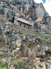 Ancient Inca ruins and stone fortifications at Ollantaytambo, Peru, showcasing impressive pre-Columbian architecture set against the dramatic Andes Mountains. A historic archaeological site rich in cu