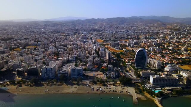 Evening sunset over Limassol, Cyprus. Aerial view of modern urban architecture and glass skyscrapers of Cyprus. Mediterranean Sea near Limassol, Cyprus. High quality footage 4k