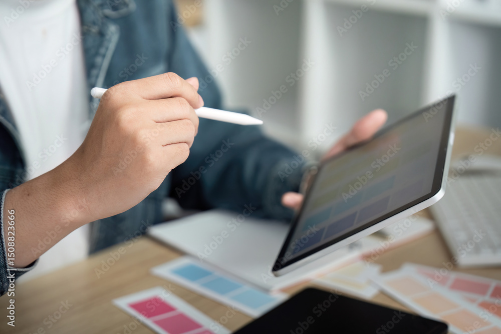 Poster creative design: professional using tablet for color selection