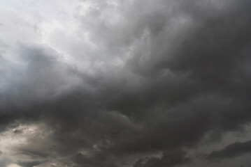 Obraz premium Dramatic dark storm thundercloud rain clouds on black sky background. Dark thunderstorm clouds rainny landscape. Meteorology danger windstorm disaster climate. Dark cloudscape storm disaster gray sky