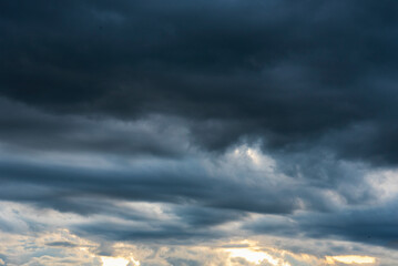 Dramatic dark storm thundercloud rain clouds on black sky background. Dark thunderstorm clouds...