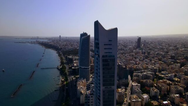 Evening sunset over Limassol, Cyprus. Aerial view of modern urban architecture and glass skyscrapers of Cyprus. Mediterranean Sea near Limassol, Cyprus. High quality footage 4k