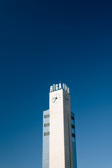 Riga, Latvia giant clock on top of a tower block with RIGA inscription in Riga, Latvia