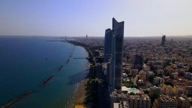 Evening sunset over Limassol, Cyprus. Aerial view of modern urban architecture and glass skyscrapers of Cyprus. Mediterranean Sea near Limassol, Cyprus. High quality footage 4k