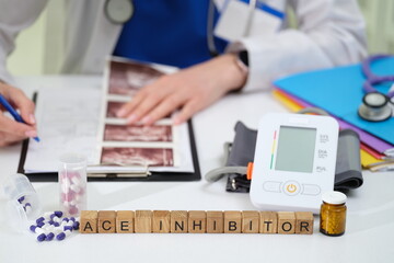 A dedicated doctor meticulously studies patient data while managing ACE inhibitor medication and...