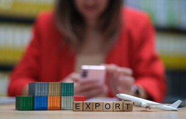 Fototapeta premium A visual representation of export with blocks, airplane, and mobile phone in a professional setting.