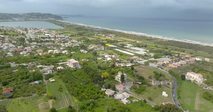 Aerial view of the Roman Amphitheatre in the archaeological site of Cuma in the province of Naples, Campania, Italy. It is an amphitheatre built by the ancient Romans on the coast of Mediterranean Sea