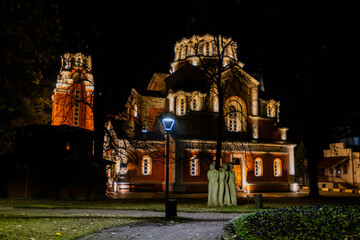 A night shot of a brightly lit Orthodox church with traditional medieval architecture.