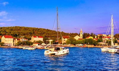 Zlarin island , Croatia, Sibenik archipelago: Sunset view of the waterfront with boats in the port, Dalmatia, coral jewellery island