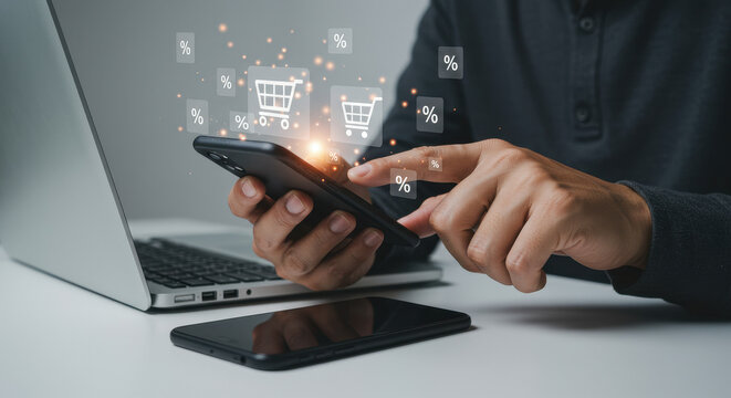 Online Shopping Sale: One man browses deals with a mobile phone and laptop, seeking promotions for digital purchase decisions.