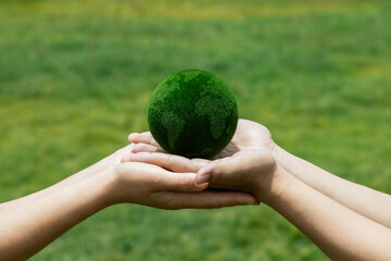 Hands Holding Green Planet Symbolizing Environmental Sustainability
